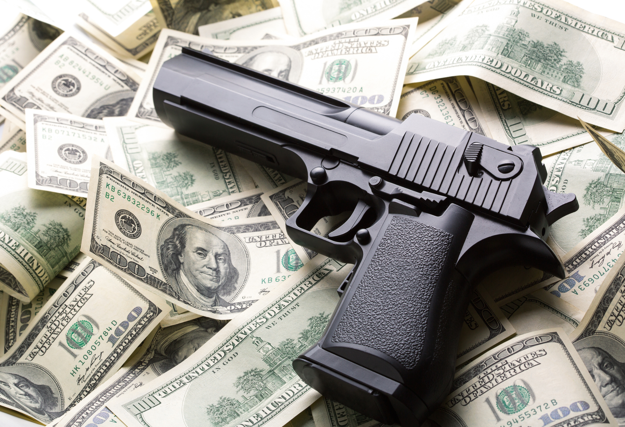 gun sitting on money from a tax return